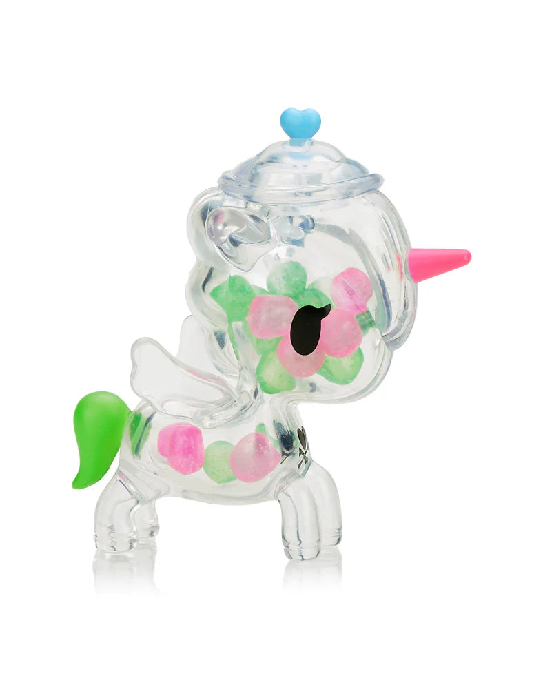 Sugar Shop Unicorno Blind Box featuring a collectible Unicorno figure as a transparent candy jar with candy-shaped pieces inside, sealed in silver foil.