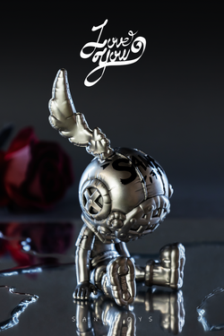 Close-up of a silver toy with black text, featuring a deer head and a rose, part of the Good Night Series-Love balloon-Silver.