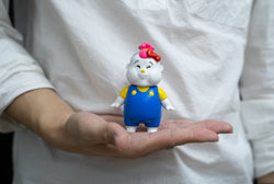 Hello Kitty RMX 2021 Project - Hello Kitty x CHUBBI CHUNK: Person holding toy figurine of a baby.