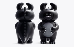 DINO UAMOU Black toy figures, close-up view of two plastic toys, soft vinyl, 14cm height, made in Japan.