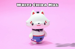 White Chiba Hug by HUGMe, a toy animal figurine with blue shorts and a bow tie, and red ears with blue pants, made of resin, 3 inches tall.