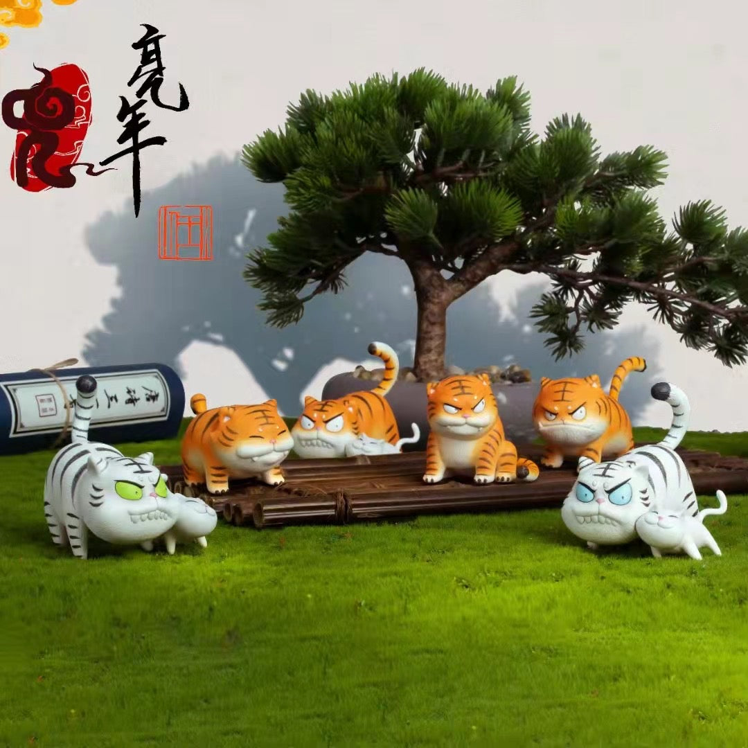 A group of small tiger statues and cat figurines outdoors.