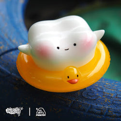 Toy tooth on a rubber duck, close-up of yellow rubber ducky, from Swimming Teeth by Funk Toy, soft vinyl, 6.8 cm height.