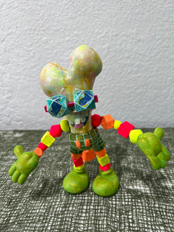 Toy figurine with colorful beads, objects, and a cube with balls, close-ups of various objects, including a sculpture and a painting.