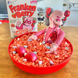 A bowl of cereal with a toy figurine, featuring a custom design on a Kaws platform by Zard Apuya.