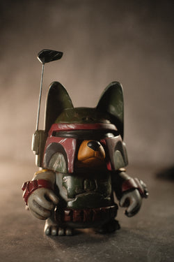 A toy animal figurine with a helmet and golf club, part of the limited 15-piece Boba Gwen by Eric Noah collection.