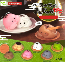 Smooth Manju Crab Buns Gacha Series toy and cartoon characters on table.