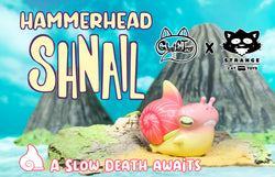 Hammerhead Shnail vinyl toy by Ghost Fox Toys on display with a cartoon cat and toy snail.