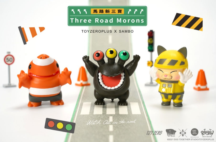 R.U.Y.H. SAMBO - Momoco X Shon X Robin (Three Road Morons) toys on a road, including a yellow and black toy, a black toy with three eyes, and a small orange toy with white stripes.