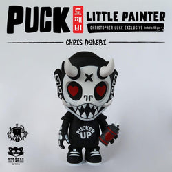 A toy figure of Puck, a mischievous goblin from Korean folklore, holding a spray can, part of the Little Painter “Pucker Up” edition.